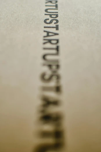 a close up of a book on a table, by karolis strautniekas, unsplash, letterism, starship, in 2 0 1 2, standup, on vellum