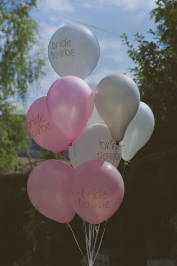 a bunch of pink and white balloons with writing on them, multi - coloured, lifestyle, petite, engraved