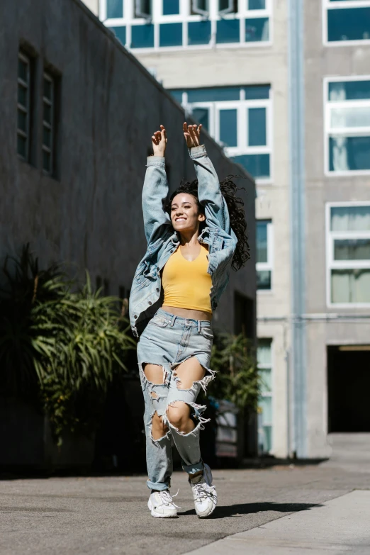 a woman jumping in the air on a skateboard, trending on pexels, happening, artist wearing torn overalls, bella poarch, pose(arms up + happy), hollywood promotional image