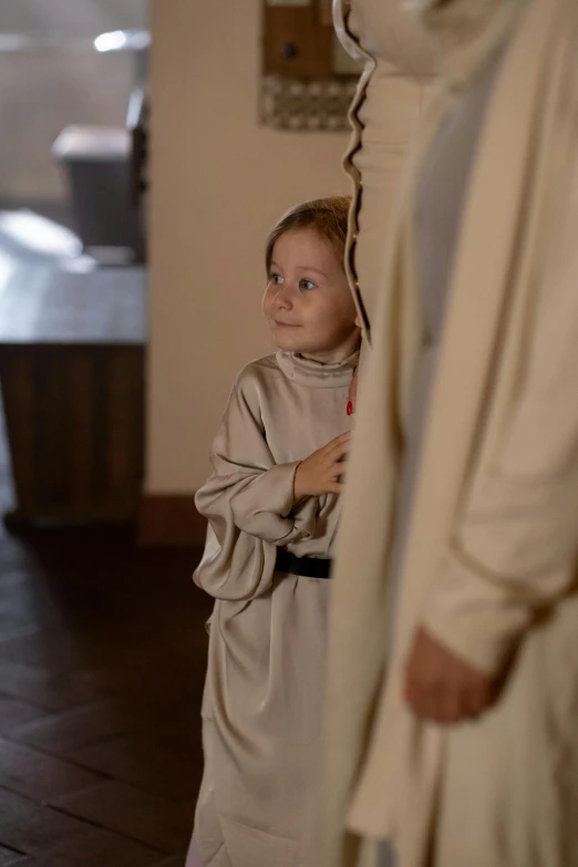 a little boy standing next to a man in a robe, inspired by Francesco Hayez, happening, film still from star wars, in a church. medium shot, promo image, girl venizian