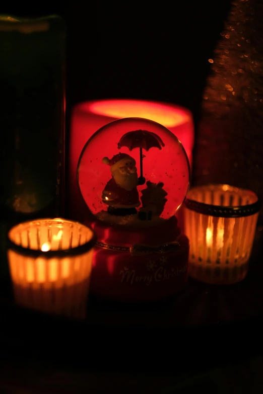 a couple of candles sitting on top of a table, a picture, inside a snow globe, low-light photograph, slide show, holiday season