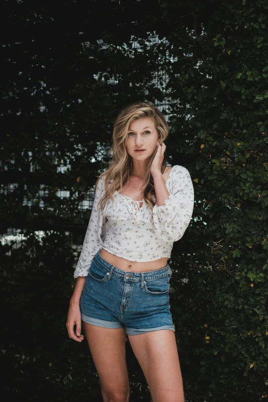 a beautiful young woman standing in front of a bush, unsplash, daisy dukes, wearing a designer top, a blond, 5 0 0 px models