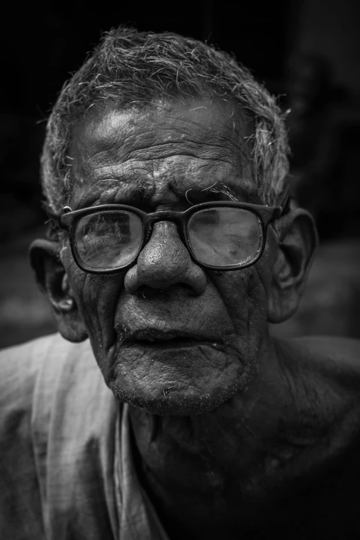 a black and white photo of a man with glasses, a black and white photo, pexels contest winner, hyperrealism, frail, wise old indian guru, a photo of a man, in square-rimmed glasses