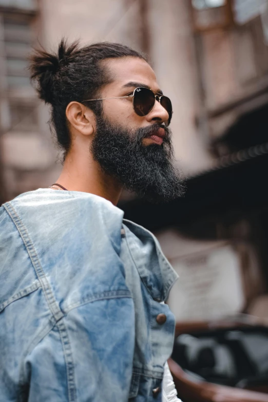 a man with a long beard wearing a denim jacket, trending on pexels, topknot, a photo of a disheveled man, wearing shades, trending on gc society