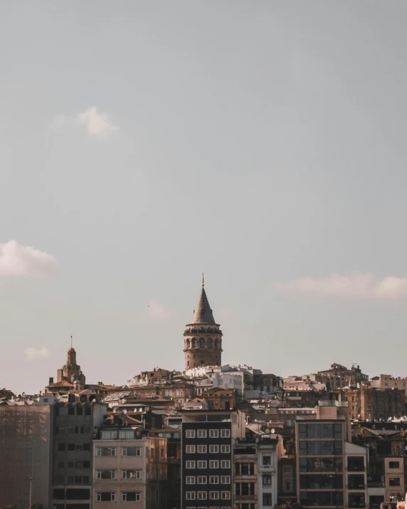 a view of a city with a clock tower in the background, mixture turkish and russian, trending on vsco, background image, multiple stories