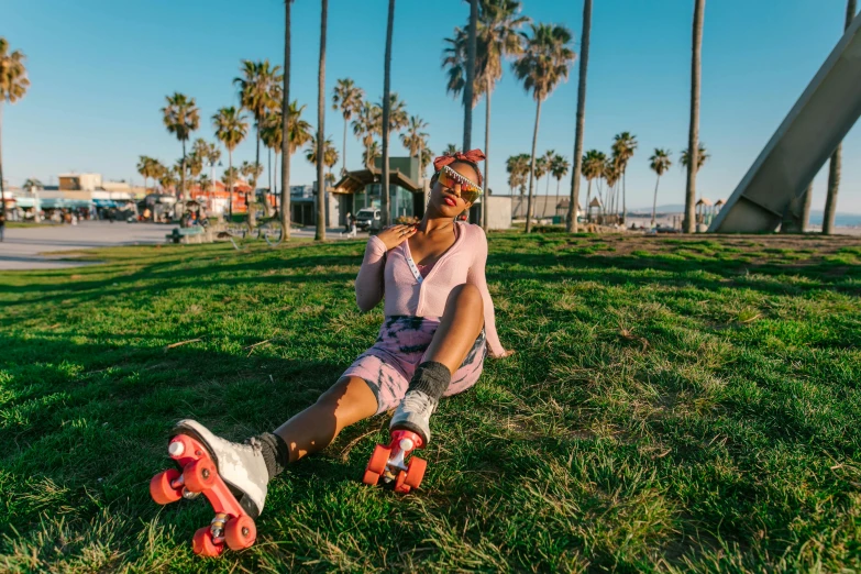 a woman sitting on top of a lush green field, unsplash contest winner, graffiti, butterfly roller skates, santa monica beach, with palm trees in the back, woman with rose tinted glasses