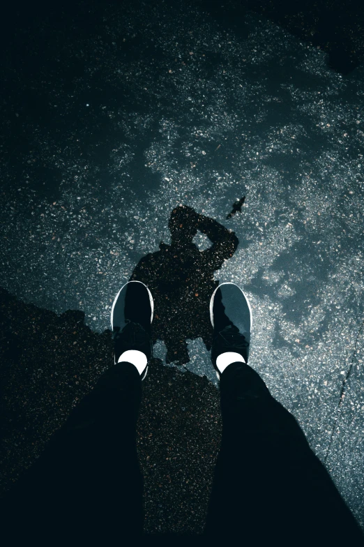 a person standing in the middle of a puddle of water, an album cover, by Niko Henrichon, unsplash contest winner, sneaker photo, dark shadow, starry, fear of heights