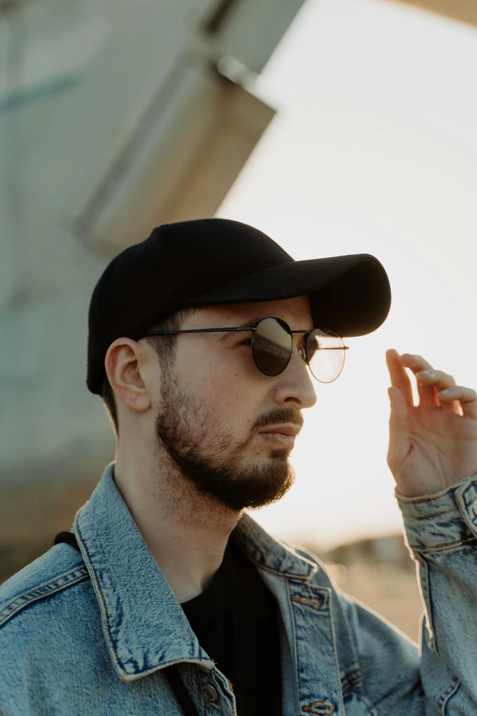 a man wearing a black hat and sunglasses, inspired by Dan Smith, trending on pexels, thin beard, young greek man, highly reflective, discord profile picture