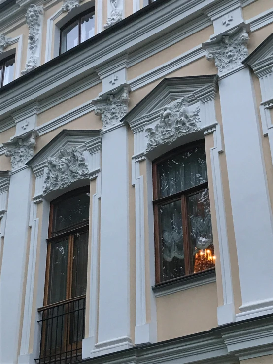 a clock that is on the side of a building, bay window, in the evening, white elegant baroque design, photograph taken in 2 0 2 0