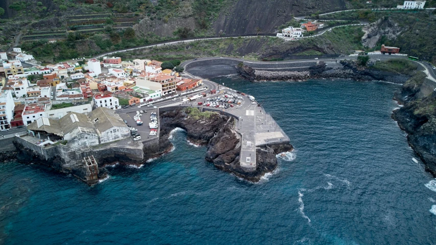 a large body of water next to a small town, by Carlo Martini, pexels contest winner, happening, black sand, alvaro siza, square, port