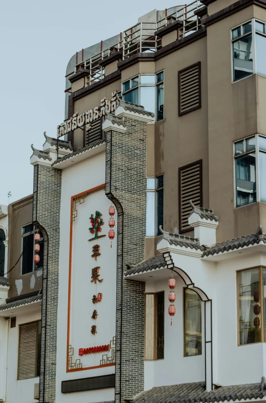 a building with chinese writing on the side of it, trending on pexels, art nouveau, residential area, low quality photo, holiday, square