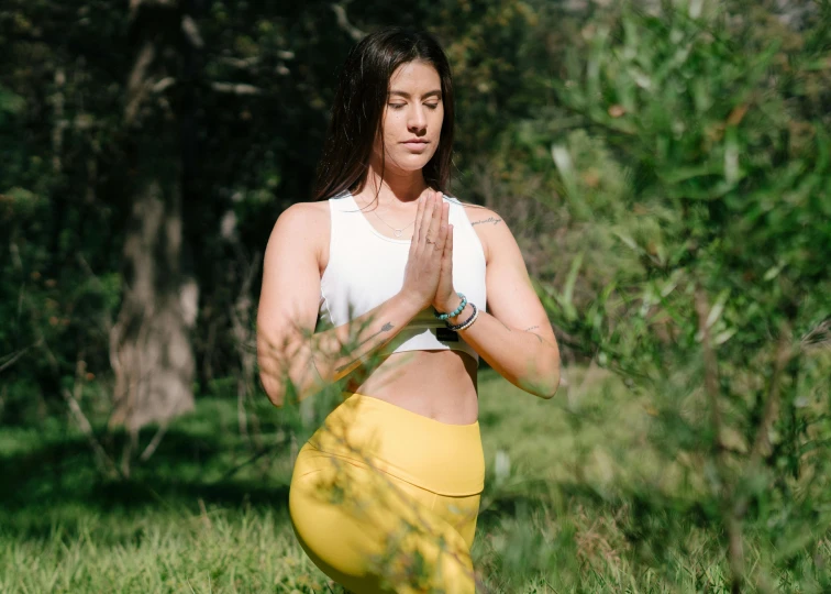 a woman in a white top and yellow pants doing yoga, a statue, trending on pexels, avatar image, manuka, high quality image, meadows