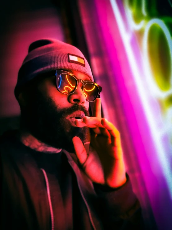 a man smoking a cigarette in front of a neon sign, an album cover, unsplash, mc ride, profile image, thick glasses, nug pic