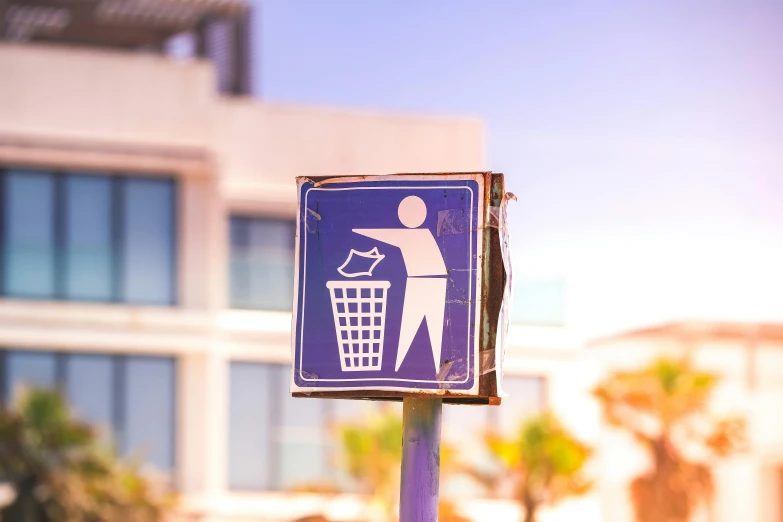 a blue and white sign with a person throwing a trash can, by Julia Pishtar, unsplash, in a beachfront environment, avatar image, pub, miscellaneous objects