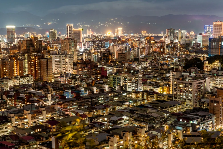 a view of a city at night from the top of a hill, pexels contest winner, mingei, in a tropical and dystopic city, slide show, japanese downtown, lots of buildings