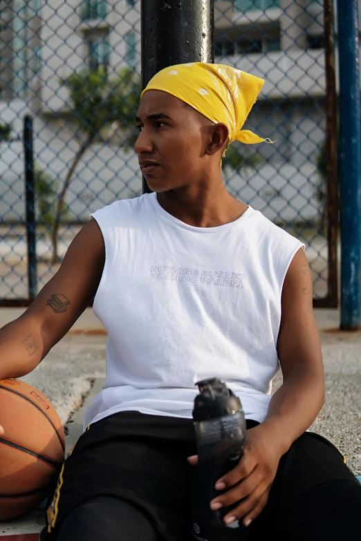 a woman sitting on a basketball court holding a water bottle, by Everett Warner, trending on dribble, nonbinary model, brazil, profile image, white tank top