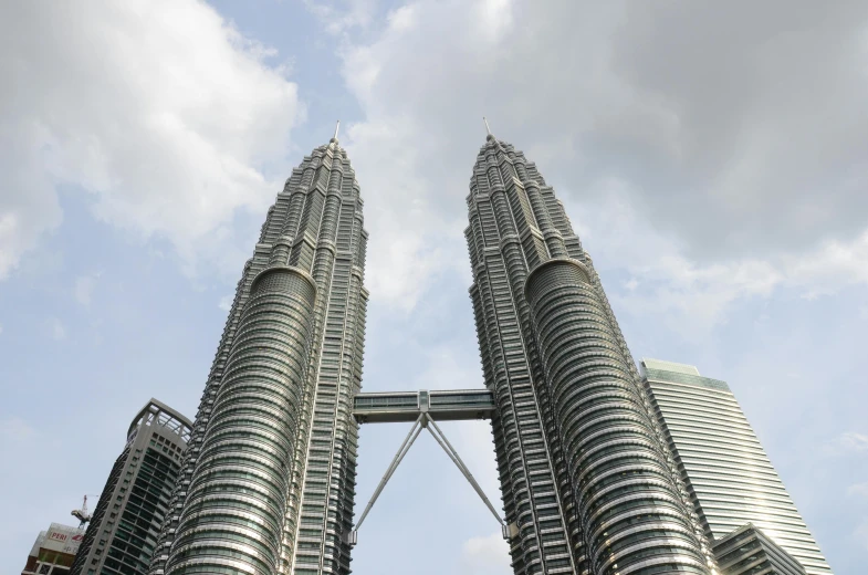 a couple of tall buildings sitting next to each other, pexels contest winner, hurufiyya, malaysian, 🦩🪐🐞👩🏻🦳, huge spines, front view