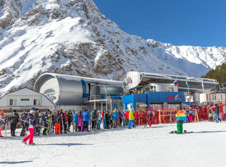 a group of people standing on top of a snow covered slope, monorail station, tubing, guillaume tholly, snacks