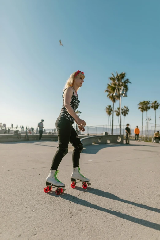 a woman riding a skateboard down a street, by Niko Henrichon, standing near the beach, rollerskaters, profile image, beth cavener