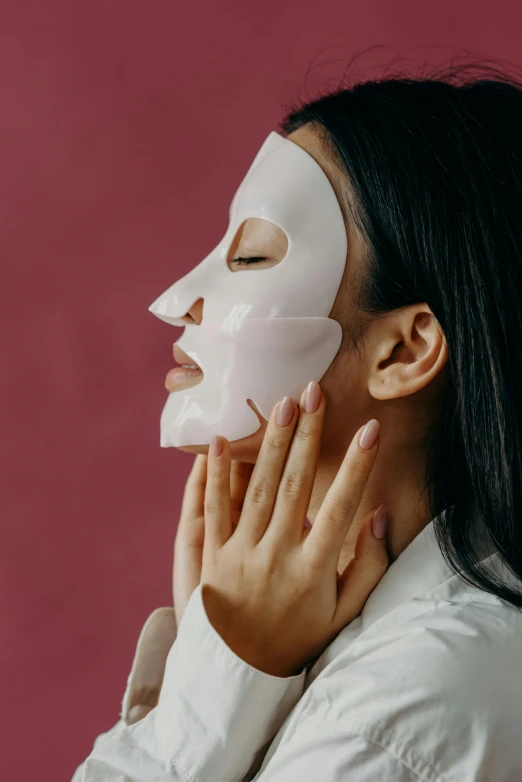 a woman with a white mask on her face, trending on pexels, asian female, square facial structure, face and body, glossy