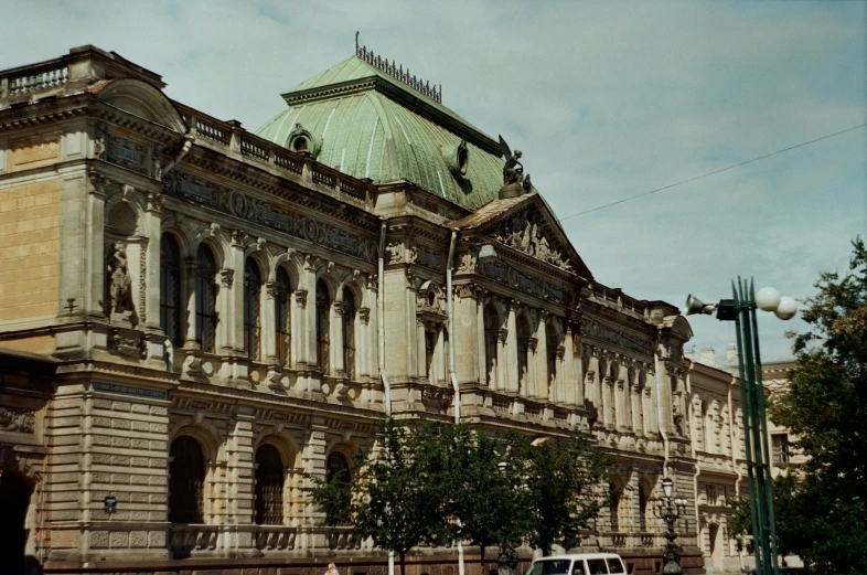 a car is parked in front of a large building, inspired by Vasily Surikov, pexels contest winner, baroque, square, government archive photograph, looking across the shoulder, theatrical
