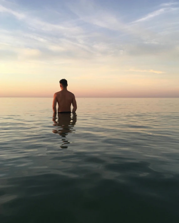 a man standing in the middle of a body of water, profile image, fit pic, lgbtq, multiple stories