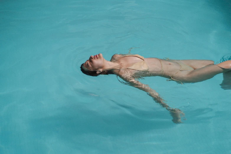 a woman swimming in a pool with a frisbee, inspired by Elsa Bleda, pexels contest winner, hyperrealism, alessio albi, sunny day time, spa, tansparent water