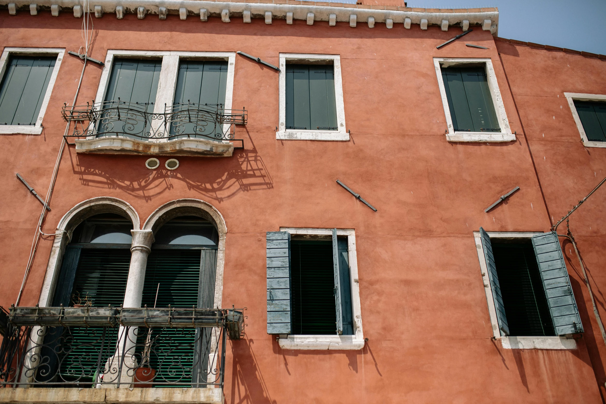 a red building with lots of windows and balconies, inspired by Canaletto, pexels contest winner, renaissance, pink and green, patina, portrait image, 3 doors