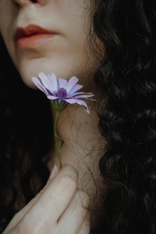 a close up of a person holding a flower, inspired by Elsa Bleda, trending on pexels, renaissance, black long curly hair, profile image, violet myers, thoughtful )