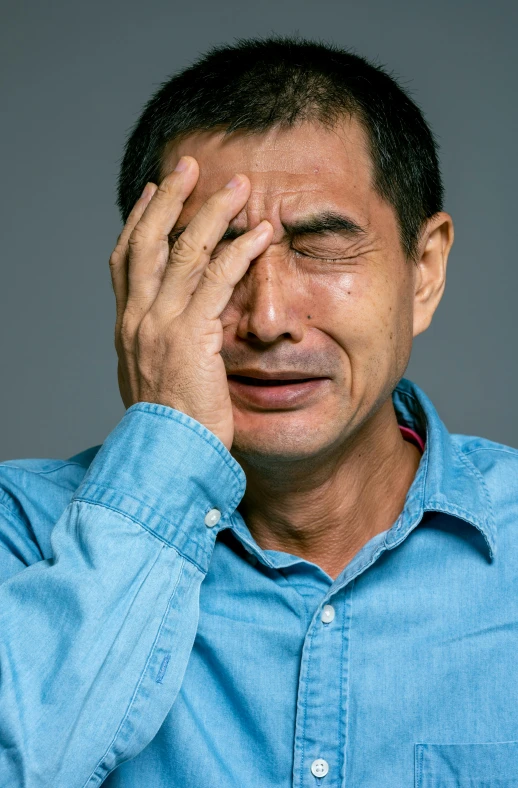 a man covers his eyes with his hands, a stock photo, pexels, hyperrealism, tony hawk crying, ernie chan, movie still of a tired, gregg araki