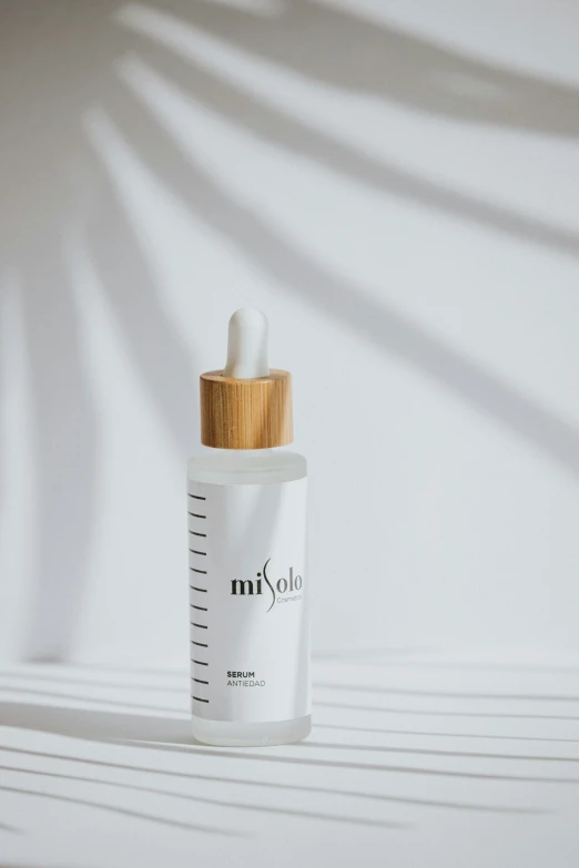 a bottle of milk sitting on top of a table, photoshoot for skincare brand, mikko, detailed product image, 3/4 front view