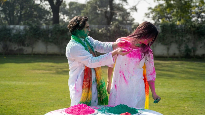 a couple of people that are standing in front of a cake, a colorized photo, pexels contest winner, color field, wearing a kurta, paint is falling off, playing, white