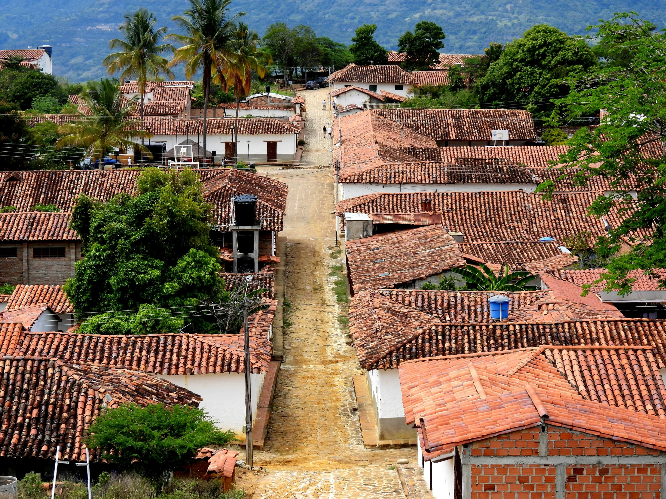 an aerial view of a village with mountains in the background, a portrait, flickr, las pozas, square, background image