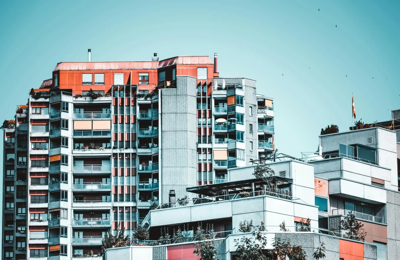 a group of tall buildings sitting next to each other, a colorized photo, pexels contest winner, brutalism, orange and teal color, urban house, swedish urban landscape, slide show