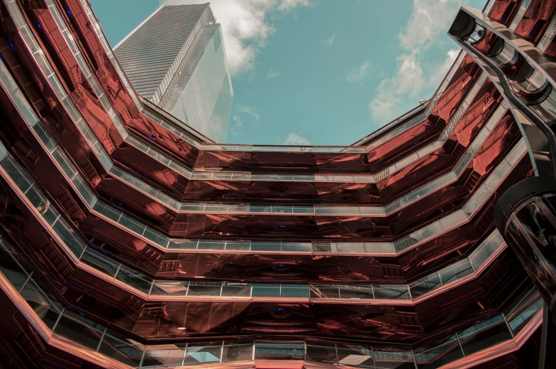 a very tall building with a lot of windows, inspired by Beeple, unsplash contest winner, metallic red, view from ground level, panoramic anamorphic, reflections in copper