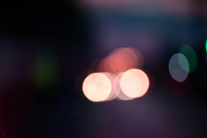 a close up of a cell phone with blurry lights in the background, a picture, by Attila Meszlenyi, unsplash, light and space, headlights, 15081959 21121991 01012000 4k, light gradient, light leaks