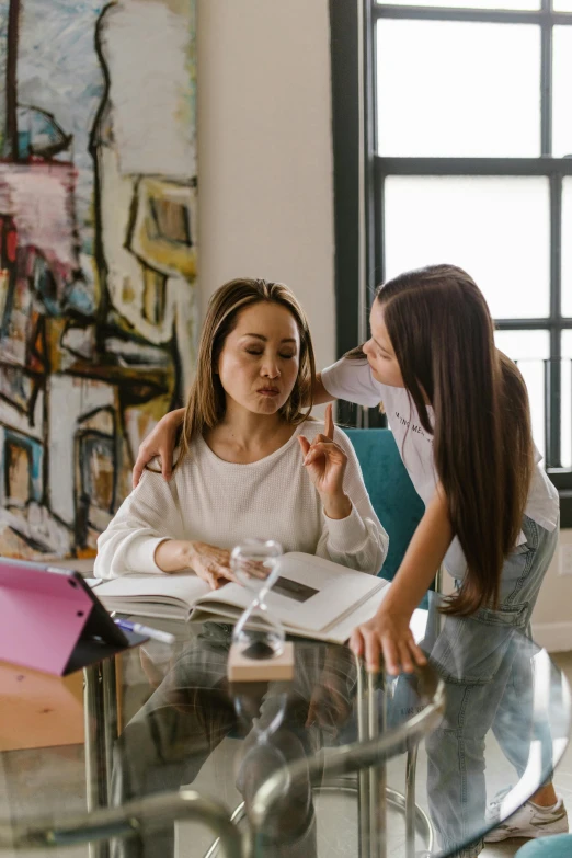 a couple of women that are sitting at a table, trending on pexels, academic art, woman holding another woman, multi-part, transparent, at home