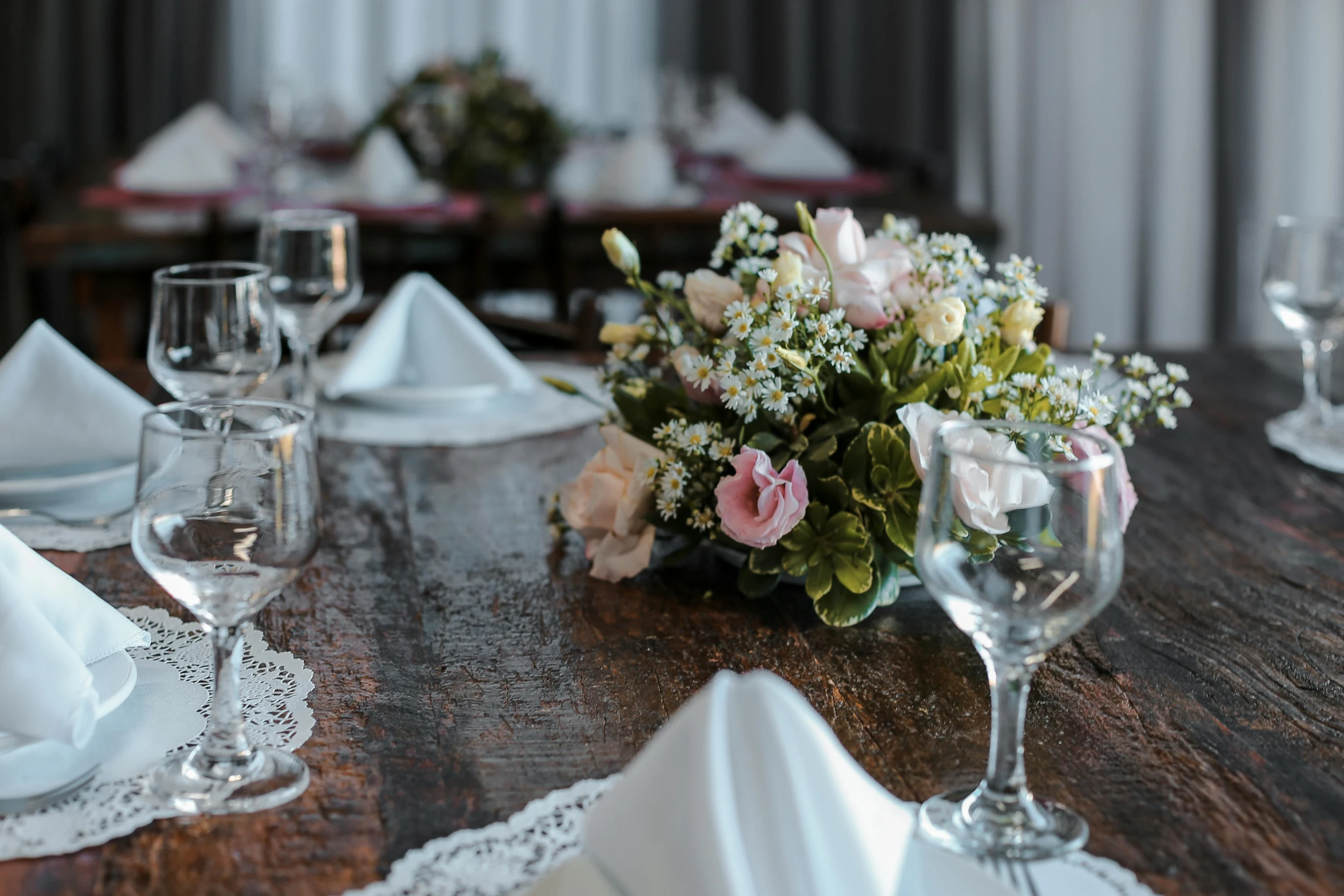 a wooden table topped with white and pink flowers, renaissance, restaurant, fine lace, front and center, celebrating