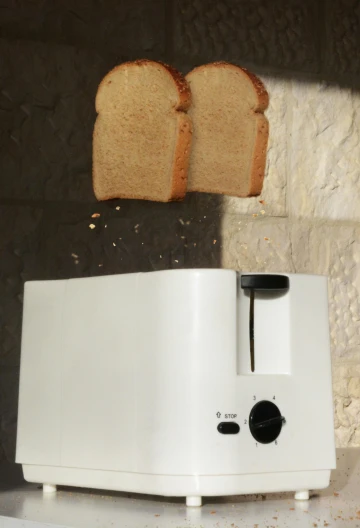 a toaster with two slices of bread coming out of it, by Ben Zoeller, reddit contest winner, ap news photo, a tall, white, ignant