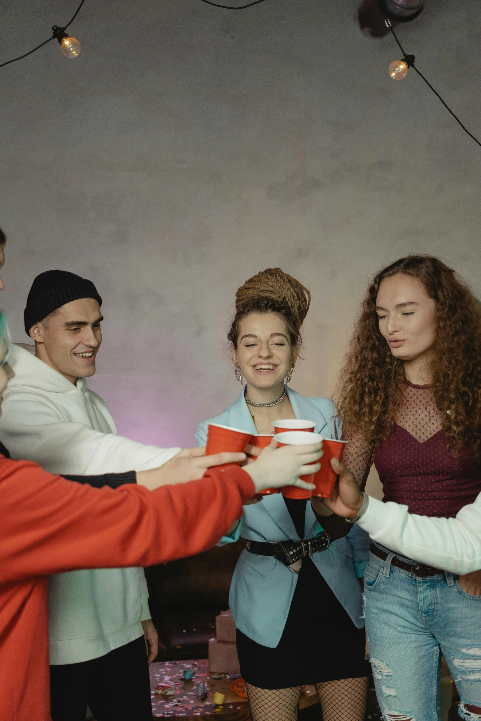 a group of people standing around each other, trending on pexels, renaissance, holding a drink, teenage, lgbt, wearing red clothes