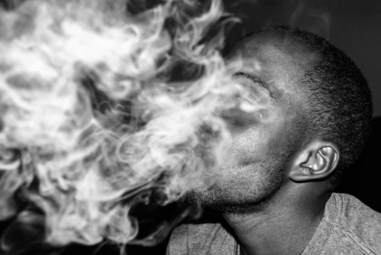 a black and white photo of a man smoking a cigarette, a black and white photo, by Daniel Gelon, kobe bryant, weed, firebreathing, 2019 trending photo