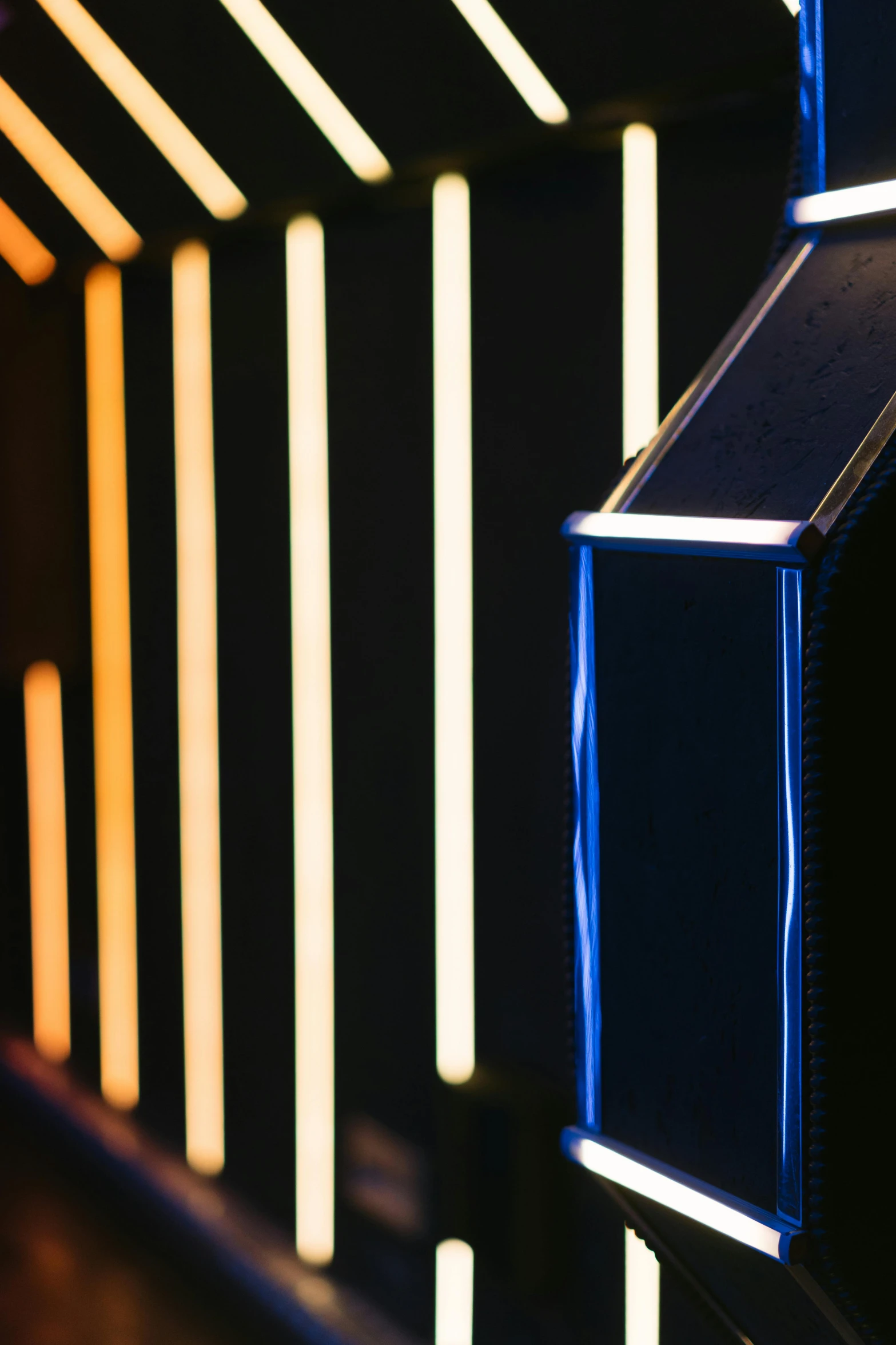 a wall that has some lights on it, an album cover, by Doug Ohlson, unsplash, light and space, blue and yellow ribbons, nvidia rtx reflections, close up shot from the side, award winning. 4 k