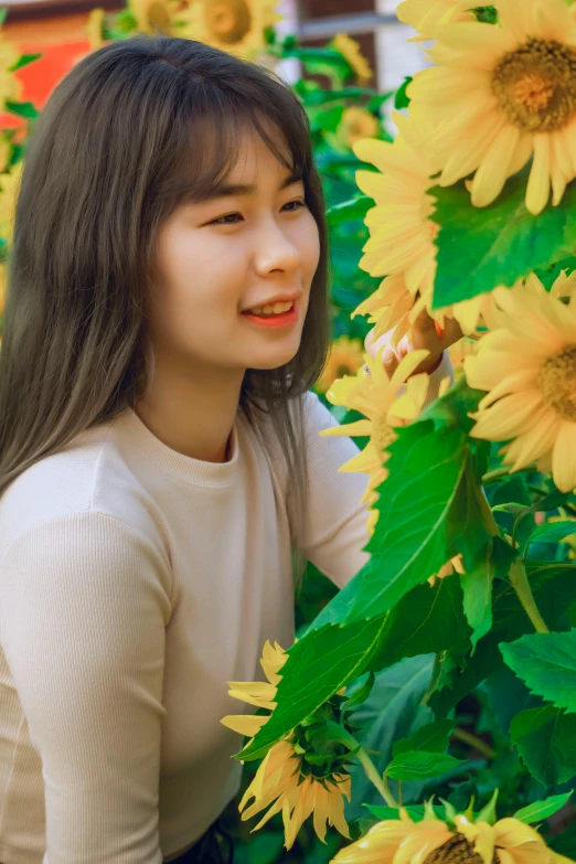 a woman standing in front of a field of sunflowers, a picture, inspired by Kim Jeong-hui, young adorable korean face, color photograph, low detail, bae suzy