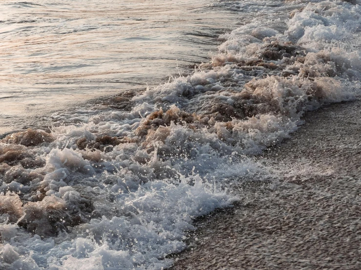 a person riding a surfboard on top of a sandy beach, running water, insanly detailed, in the evening, zoomed in