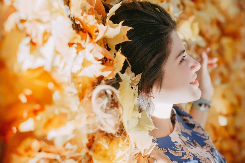 a woman standing in front of a wall of leaves, a photo, trending on pexels, lying down, avatar image, girl with brown hair, thumbnail