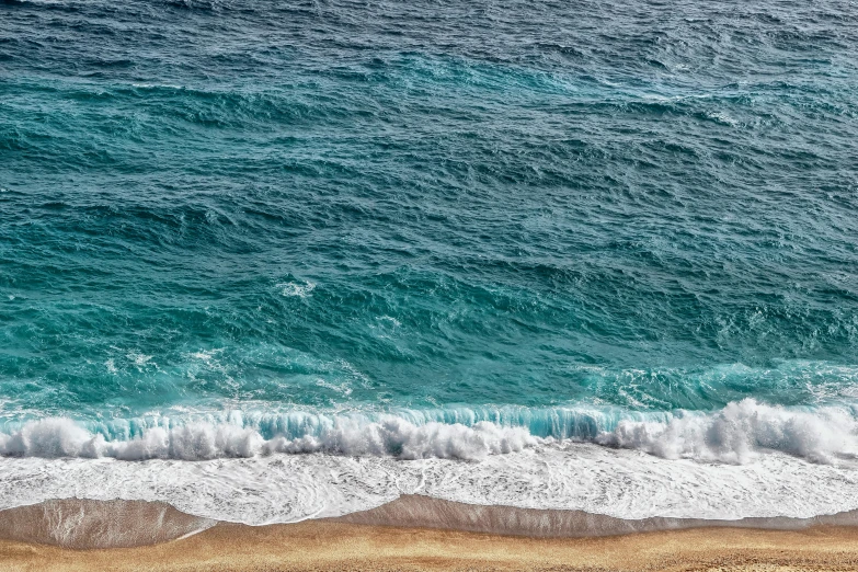 a large body of water next to a sandy beach, by Carey Morris, pexels contest winner, azure waves of water, mediterranean, thumbnail, ultra textured