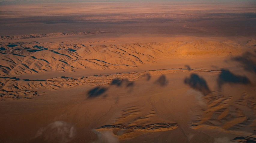 a view of the desert from an airplane, pexels contest winner, mongolia, early morning light, 2 0 2 1 cinematic 4 k framegrab, craters