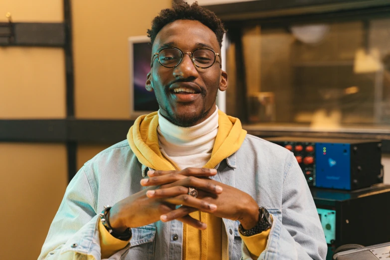 a close up of a person wearing a scarf, an album cover, inspired by Barthélemy Menn, trending on pexels, he is wearing a brown sweater, twitch streamer, wearing gold glasses, chappie in an adidas track suit