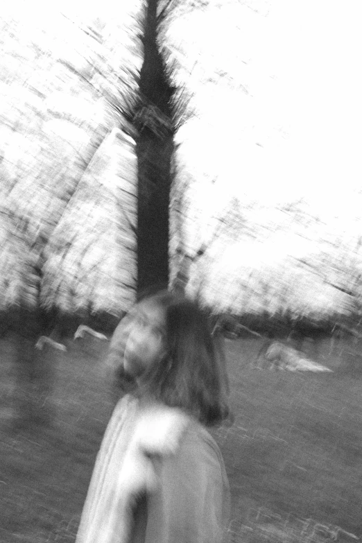 a blurry photo of a person holding an umbrella, a black and white photo, tumblr, ((trees)), ((portrait)), spinning whirlwind, blurry and glitchy