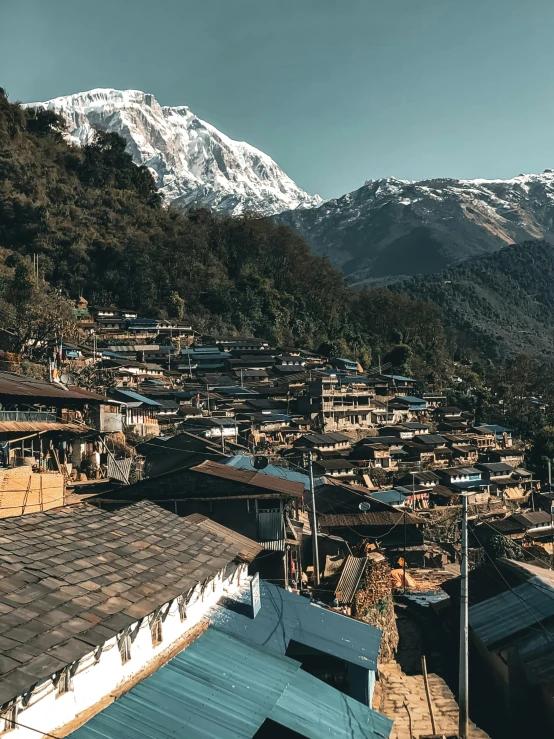 a village with a mountain in the background, unsplash contest winner, nepali architecture buildings, bird\'s eye view, slide show, slightly sunny